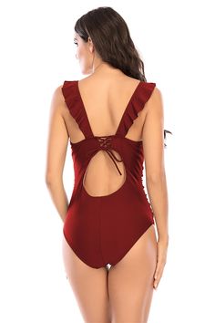 This feminine one piece swimsuit is trimmed with ruffles. The deep plunging v-neck is a super flattering neckline. The torso features ruching and tummy control, making this an ideal one piece for many body types. The back has a tie with a keyhole cutout detail below it. Tummy control ruching V-neck with ruffles Tie in back with keyhole cutout Polyester, Spandex NOTE: All swimwear is final sale, no returns are accepted V-neck Ruffled Swimwear For Pool, Ruffled V-neck Swimwear, Solid Color V-neck Swimwear With Ruffles, Solid Color Ruffled One Piece For Poolside, Solid V-neck Swimwear With Ruffles, Solid Ruffled One Piece For Poolside, Solid Ruffled One-piece For Poolside, Ruffled One-piece Swimming Suit, Solid Ruffled One Piece Beachwear