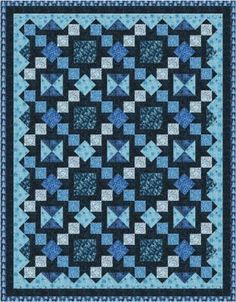 a blue and black quilt with squares on the front, one square in the middle