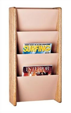 a wooden magazine rack holds magazines and magazines on it's sides, as well as two