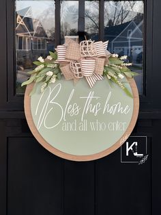 a door with a wreath on it that says, bless this home and all who enter