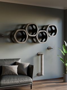 a living room filled with furniture and a cat scratching post mounted to the side of a wall