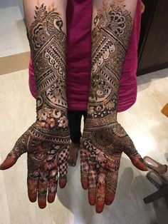 two hands with henna designs on them