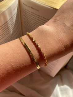 Set of two gold bracelets  Glow in gold with this bracelet stack, featuring our sparkly Rock chain, a new and unique design, made from rectangular links that are connected widthwise into a twisted row. Which creates a textured, tubular appearance with an excellent sparkle. The unique style creates a elegant, simple but statement bracelet  Stacked with our sleek and smooth herringbone bracelet, which is equally as dazzling with its reflective snake like design. Both made with plated stainless ste Unique Gold Bracelet Designs For Women, Trendy Snake Chain Bracelets As Gifts, Trendy Snake Chain Bracelet For Gifts, Trendy Tarnish Resistant Rectangular Bracelets, Simple Gold Bracelet, Gold Bracelet Stack, Delicate Gold Bracelet, Silver Bracelet Stack, Gold Arm Band