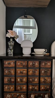 a dresser with drawers and a mirror on top