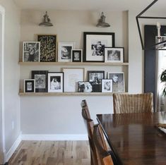 a dining room table and some pictures on the wall