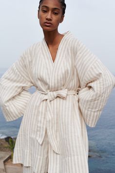 "Wrap yourself in comfort and style with our short striped linen robe with pockets. Crafted from luxurious 100% linen from a medium weight fabric, this robe is perfect for lounging at home or adding a touch of elegance to your morning routine. The timeless striped design adds a chic flair, while the convenient pockets provide functionality and convenience. Whether you're sipping your morning coffee or unwinding after a long day, this robe is sure to become your go-to favorite. Treat yourself to luxury and relaxation with our short striped linen robe with pockets ️.  READY FOR GIFT!  ✨ Gift message available (please write the message in the comments field).   All packages are packed in our original eco-friendly white boxes made from recycled paper. DETAILS: - Pure 100% linen fabric - OEKO-T Cream Summer Robe For Loungewear, Cream Summer Daywear Robe, Beige Robe For Spring Loungewear, Spring Cream Robe For Loungewear, Beige Spring Loungewear Robe, Relaxed Fit Beige Robe For Loungewear, Linen Robe For Daywear, Beige Relaxed Fit Robe For Loungewear, Summer Linen Lounging Robe