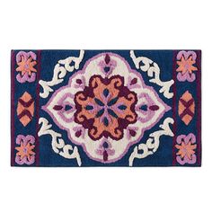 a blue and pink rug with an ornate design on the bottom, in front of a white background