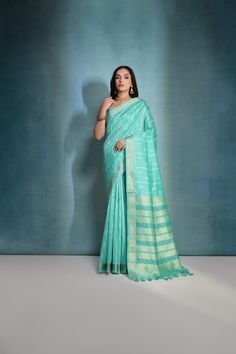 Fabric : Raw Silk Color : Turquoise Length : 5.5 Meter Saree + 0.80 Meter Blouse Saree Work : Ikkat Woven All Over Border : Zari Woven Border Wash : Dry Clean Only Product color may little differ as per the brightness or color settings of your device. Semi-stitched Turquoise Saree With Self Design, Turquoise Semi-stitched Saree With Self Design, Turquoise Traditional Wear With Zari Weaving, Turquoise Saree With Cutdana For Puja, Turquoise Silk Saree With Pallu Detail, Turquoise Pallu Saree, Elegant Turquoise Saree For Diwali, Elegant Turquoise Traditional Wear For Festive Occasions, Turquoise Saree With Pallu In Traditional Drape