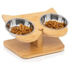 two metal bowls with food in them on a wooden stand