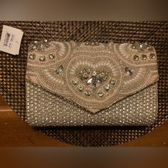 Aldo Clutch With A Tag: Beige/Bronze Fabric With A Flap Decorated With Rhinestones & Sequins. Detachable Silver Metal Chain Handle. Inside Pocket. Snap Closure. Flaw: Fabric Damage Inside, Not Visible From Outside. See Pictures. Sold As Is. Chic Clutch With Silver-tone Hardware And Pouch Shape, Red Clutch Bag, Luxury Rectangular Clutch With Silver-tone Hardware, Silver Clutch Bags With Silver-tone Hardware, Luxury Silver Clutch With Silver-tone Hardware, Gold Clutch Bag With Silver-tone Hardware, Yellow Clutch, Satin Purses, Aldo Bags