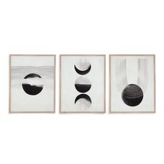 three black and white paintings hanging on a wall