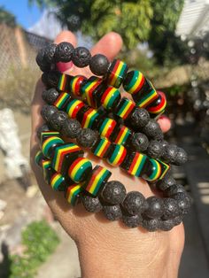 "These bracelets are a fun combination of round, squared and varied sized resin beads and black lava beads.. Resin beads are black with fun yellow, red and green stripes.  The variation of sizes makes them really unique and fun. Perfect for the lover of Rasta and all things Jamaica. Woman's wrist approx. 6\" ONLY AVAILABLE IN SIZE LISTED" Black Rectangular Beaded Bracelets For Gift, Rectangular Black Beaded Bracelets For Gifts, Casual Black Beaded Bracelets With Large Beads, Casual Black Beaded Bracelet With Large Beads, Black Wristband With Colorful Beads Gift, Black Wooden Beads Bracelet As Gift, Black Bracelets With Large Beads For Gift, Black Bracelets With Large Beads As Gift, Casual Black Wristband With Colorful Beads