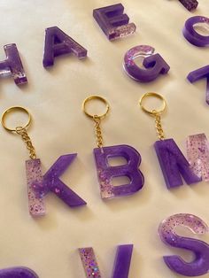 the letters are made out of plastic and have gold keychains attached to them