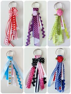 six different colored ribbons are hanging from the handles of each keychain, and one has a flower on it