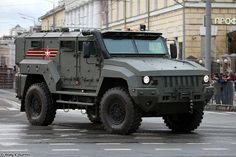 an army vehicle driving down the street