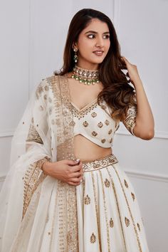 White lehenga with gold dori, aari and sequin embroidery. Comes with blouse and organza dupatta.
Component: 3
Pattern: Embroidery
Type Of Work: Sequin, Dori and Aari
Neckline: V neck
Sleeve Type: Half
Fabric: Chanderi and Organza; Lining: Shantoon
Color: White
Other Details: 
Dupatta with embroidered cutwork border
Blouse with curved hem
Cutwork detail waistband
Note: Only selling the product mentioned in the description from the video.
Occasion: Wedding - Aza Fashions Jigar Mali, White Lehenga, Embroidered Lehenga, Types Of Work, Sequin Embroidery, Luxury Sale, Organza Dupatta, Pattern Embroidery, Sequins Embroidery