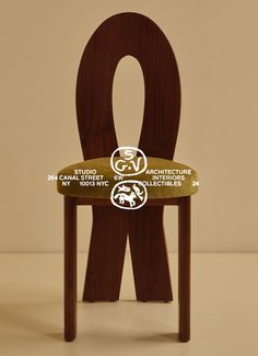 a wooden chair with an amp symbol on it