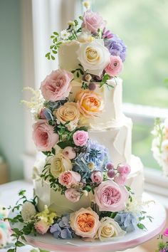 a multi - tiered wedding cake decorated with flowers