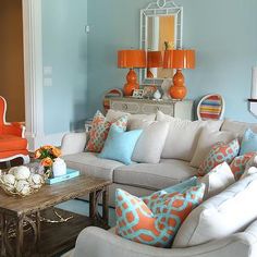 a living room with couches, chairs and tables in it's center area