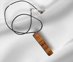 Wooden pendant necklace Handcrafted in spalted beech design with leather cord.  Capture the essence of our iconic British woodlands wherever you go, with this timeless spalted beech necklace.  If you are looking for that perfect present for nature lover, or simply a special treat for yourself, then look no further. Spalted wood is a type of wood that has undergone a unique and natural transformation due to the presence of fungi. Spalting occurs when fungi invade the wood and begin to break it do Gift Ideas Secret Santa, Spalted Wood, Secret Santa Gift Ideas, Spalted Beech, Handmade Uk, Secret Santa Gift, Wooden Pendant, Handcrafted Necklace, Secret Santa Gifts