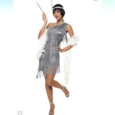 a woman in a silver flap dress holding a wand