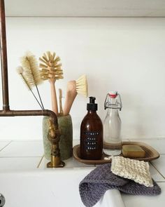 various items are arranged on the counter in front of a mirror and soap dispenser