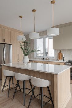 a kitchen with an island and stools in it