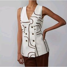 Elevate Your Wardrobe With This Stunning Brown Abstract Print Sleeveless Double-Breasted Vest From New York & Company. Perfect For Any Occasion, Whether It Be Casual, Workwear, Or Business, This Vest Is Made With High-Quality Polyester Material That Ensures Both Comfort And Durability. The Button Closure Adds A Touch Of Elegance To The Vest, While The Sleeveless Design Makes It Perfect For Layering During Any Season. This Vest Is Available In A Size L And Is Perfect For Women Who Want To Add A T Double Breasted Vest Women, Trendy Sleeveless Tops For Workwear, Sleeveless Tops With Buttons For Fall, White V-neck Vest Outerwear, Sleeveless Summer Vest, Chic Sleeveless Tops For Fall, Chic Spring Tank Vest, Chic Beige Vest For Day Out, Chic Workwear Vest Top