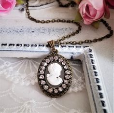 Antique inspired necklace features cameo pendant of white Victorian lady on opalescent background. The resin cameo is accented with rhinestone trim and set on antiqued bronze bezel. It suspended from a brass chain. A beautifully sweet piece for yourself or a loved one!! Pendant dimension: Approx. 30*20 mm. Please convo me for free chain length not on the list. Purchase over $40 enjoys free shipping! Coupon code 'freeshipping1'. Free Gift Wrapping on request - All items that are gift wrapped come Small Drop Earrings, Cameo Pendant Necklace, White Victorian, Inspired Necklace, Victorian Lady, Jewelry Antique, Rhinestone Trim, Cameo Necklace, Cameo Pendant