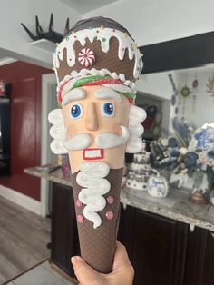 an ice cream cone with a man's face on it in the middle of a kitchen