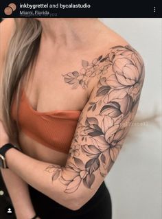 a woman with a flower tattoo on her arm