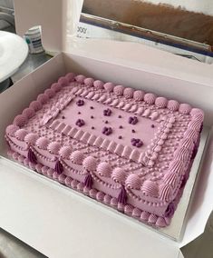 a pink cake in a box on a table