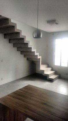 an empty room with stairs leading up to the second floor