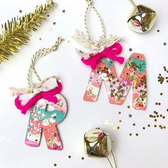 some ornaments are laying on a table with confetti and other decorations around them