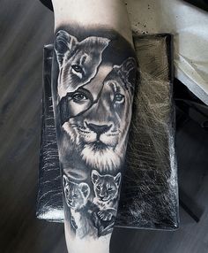 a man's leg with a lion and cubs tattoo on it