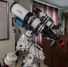 a large telescope mounted to the side of a wall