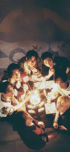 a group of people sitting around a table with lights on it in the shape of a heart