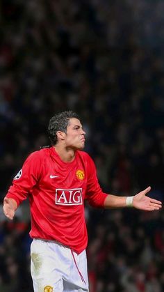 a man in red shirt and white shorts playing soccer