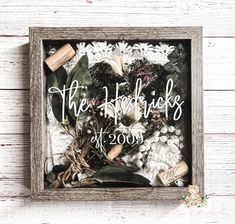 a wooden frame with flowers and wine corks on it that says the wedding picks at 2009