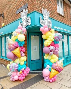 an ice cream shop decorated with balloons and streamers