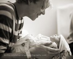 a woman holding a baby in her arms