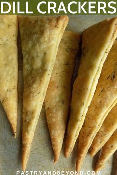 four pieces of pita bread sitting on top of a white plate with the words dill crackers written in green