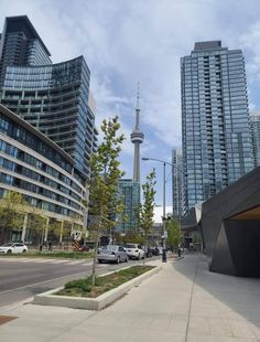 cars are parked in front of some tall buildings