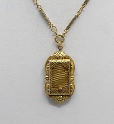 This is a antique gold filled locket made by the JJ White company. This company began business in 1896. I believe this locket is from around the turn of the century. The locket has a sliding mesh door that hides a picture within. I have paired it with a nice gold filled chain that appeared to have some age also. The locket is 1 3/4 by 7/8 inches, the chain is 19 inches. This necklace is in very good to excellent condition for its age with minimal signs of wear to the gold filled plating. The mesh door slides easily and it retains the original photo holder. This beautiful piece of history will arrive in a black velvet pouch. Free shipping. Victorian Yellow Gold Locket Necklace For Formal Occasions, Gold Engraved Jewelry For Vintage Events, Antique Gold Necklace With Rectangular Pendant, Engraved Gold Jewelry For Vintage Events, Victorian Gold Locket Necklace With Vintage Charm, Antique Yellow Gold Locket Necklace, Victorian Yellow Gold Locket Necklace, Antique Gold Locket Necklace Pendant, Victorian Style Yellow Gold Locket Necklace