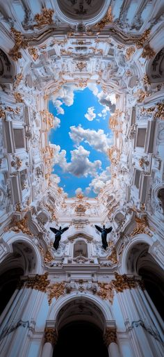 two birds are flying in the sky through an ornately decorated ceiling with clouds and gold trim