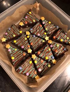 a tray filled with brownies covered in chocolate frosting and sprinkles