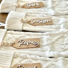 wooden name tags on white sweaters that say pennsylvania, pennsylvania, pennsylvania and pennsylvania