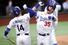 two baseball players are celebrating on the field