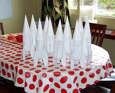 a group of white cones sitting on top of a red and white polka dot table cloth