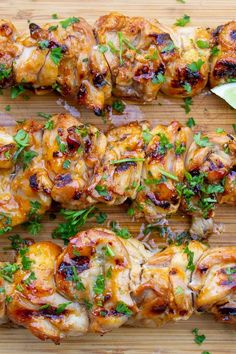 chicken skewers with cilantro and parsley on a cutting board